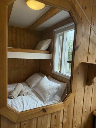 a small bed in a room with a window at Aurora Oasis on the Golden Circle in Úthlid