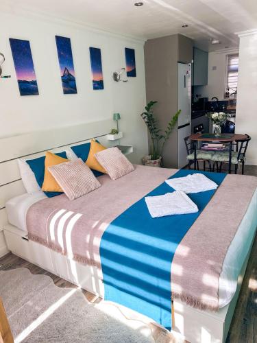 a bedroom with a large bed and a table at Studio Flat in Wythenshawe