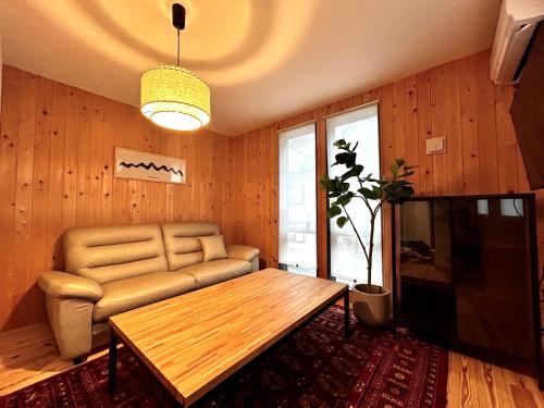 a living room with a couch and a table at 楽宿箱根 Rakuyado Hakone in Hakone
