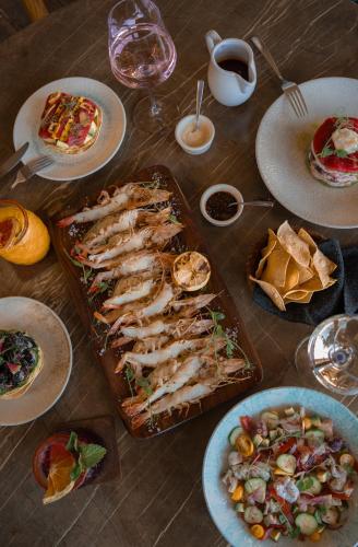 a table topped with food and plates of food at Villas Caracol in Holbox Island