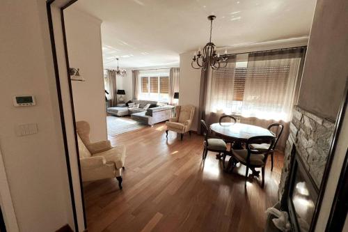 a dining room and living room with a table and chairs at Luxury 3 bedroom Grand Chalet in Perosa Argentina