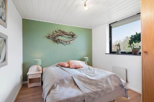 a bedroom with a bed and a window at LF11102-Struer-Snerlevej-2 in Struer