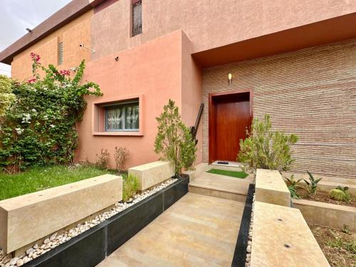 a building with a wooden door and a walkway at 5-star luxury villa with private pool in Marrakech