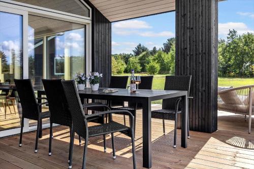 a dining table and chairs on a patio at LF12003-Spottrup-Molleparken-32 in Spottrup