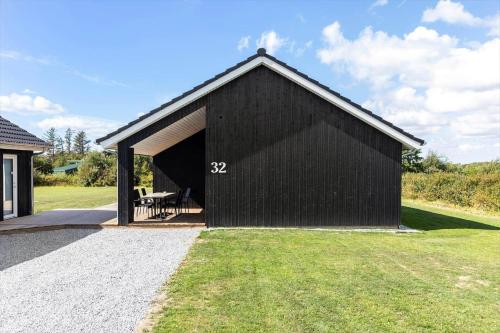 a black shed with a picnic table in it at LF12003-Spottrup-Molleparken-32 in Spottrup