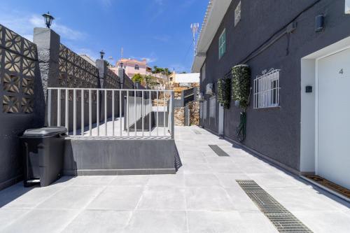 a walkway with a white gate and a building at Villa Amir in Fuengirola