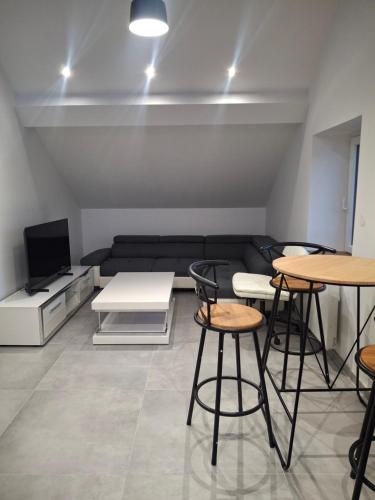 a living room with two tables and a couch at Appartement loft in Mandeure