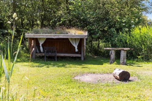 a garden with a bench and a shed at LF13175-Nykobing-Mors-Utkaeret-1 in Ejerslev