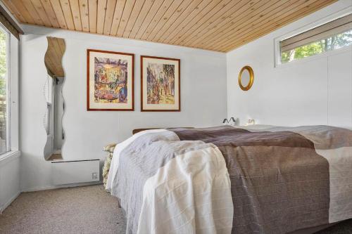 a bedroom with a bed and two pictures on the wall at LF13175-Nykobing-Mors-Utkaeret-1 in Ejerslev