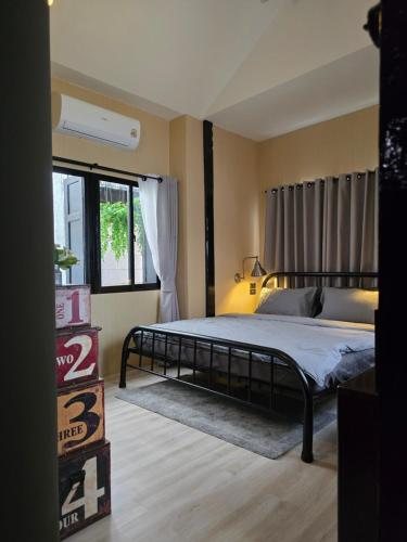 a bedroom with a bed and a large window at Carl and Ellie Home in Bangkok