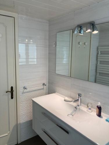 a white bathroom with a sink and a mirror at Cannes Events, Beach, Pool & Parking in Cannes