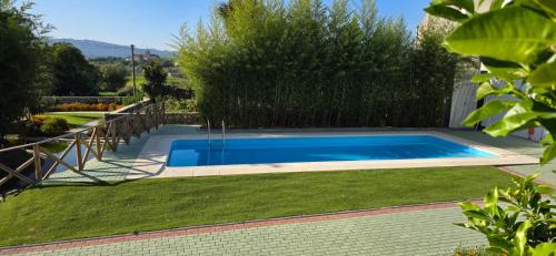 a swimming pool in the yard of a house at Casa da Biquinha in Vouzela
