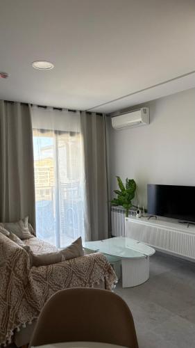 a living room with a bed and a table at DAR Sheerazade in Hammamet Nord