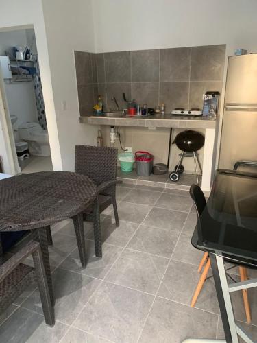 a kitchen with a table and chairs in a room at CASA JARDIN in Cancún