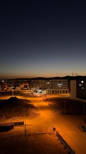 a parking lot at night with a building and street lights at DAR Sheerazade in Hammamet Nord