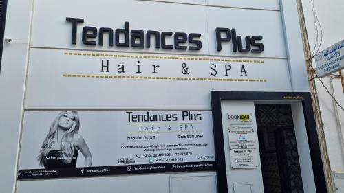 a sign for a hair and spa on the side of a building at DAR Sheerazade in Hammamet Nord