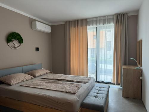 a bedroom with a bed and a large window at Apartment Victoria in Kraymorie