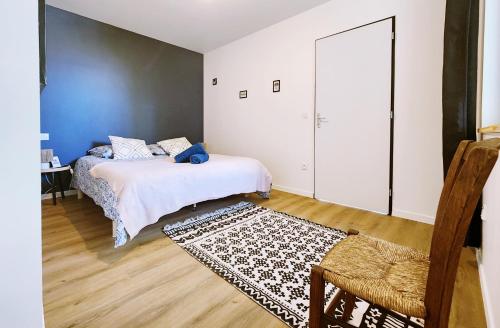 a bedroom with two beds and a rug at Polka - RDC - Centre ville - Terrasse in Auch