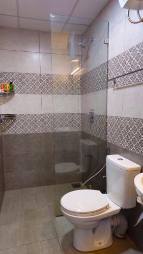 a bathroom with a toilet and a shower at Samara Villa by Trillium Residencies in Nugegoda