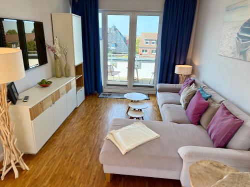TV a/nebo společenská místnost v ubytování PrimeLoft "Frische Brise" - Penthouse - Fahrstuhl - modern & geräumig - Familien - Dachterasse - Tiefgarage