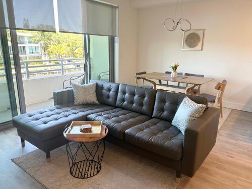 a living room with a leather couch and a table at Seahorse 316 in Sarasota