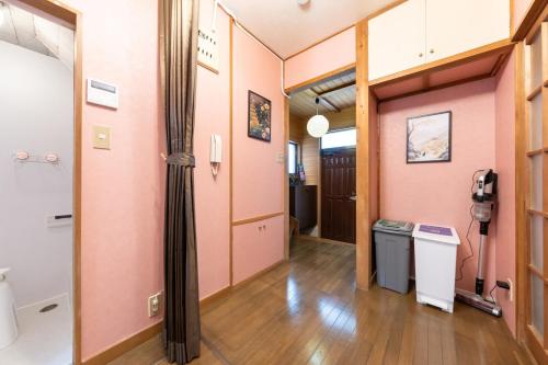a room with a hallway with a room with a hallway at Matsubara Station 2 minutes Shinjuku, Shibuya 15 minutes Pure Japanese style house where you can feel the seasons Maximum 6 people rent a house Quiet house in Tokyo