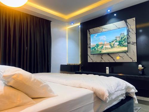 a bedroom with two beds and a flat screen tv at The janeluxe apartment in Lagos