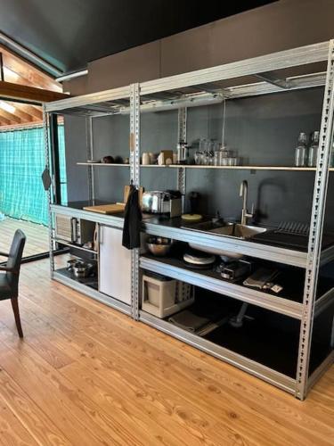 een keuken met roestvrijstalen planken in een kamer bij Logement avec terrasse in Toulouse