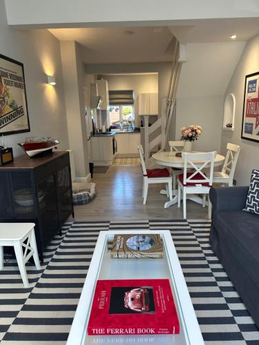 a living room with a couch and a table at Roseleigh Cottage in the Heart of Cookham in Cookham