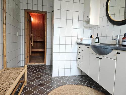a kitchen with white cabinets and a sink at FAN073-Fano-Kystvejen-13-2-sal in Fanø