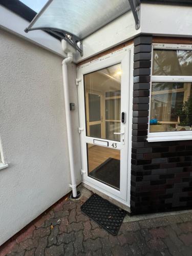 a front door of a house with a window at Cosy Home STUDIO in Croydon