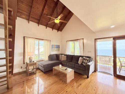 a living room with a couch and a table at Vista De Ensueno in West Bay