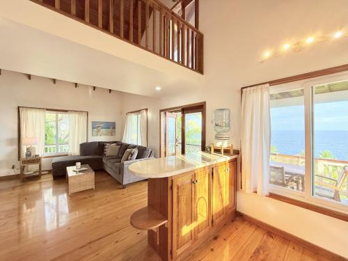 a kitchen and living room with a view of the ocean at Vista De Ensueno in West Bay