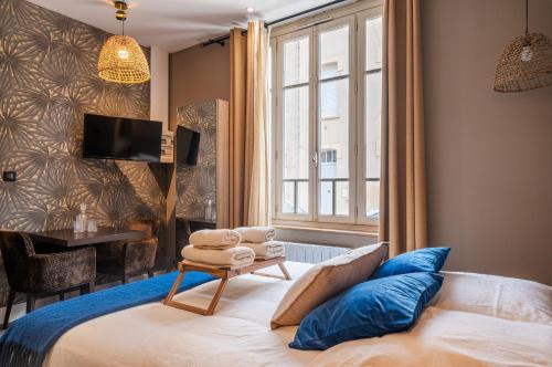 Postel nebo postele na pokoji v ubytování Le Saint-Louis - Appart'hôtel tout-équipé proche Puy-du-Fo u