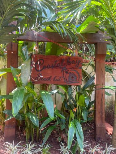 a wooden sign that reads gardening day dread lift at Coastal Bay in Thottada