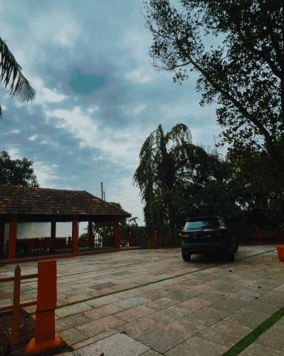a car parked in a parking lot next to a building at Coastal Bay in Thottada