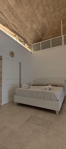 a bedroom with a large bed in a white wall at A casa di Gino in Molfetta