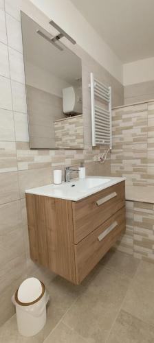 a bathroom with a sink and a toilet and a mirror at A casa di Gino in Molfetta