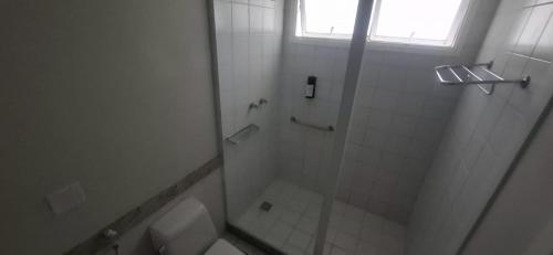 a bathroom with a shower and a toilet at Búzios Beach Resort in Buzios