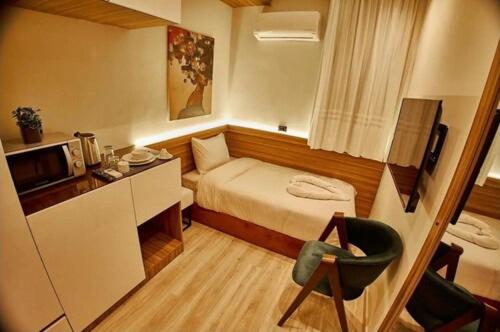 a small room with a bed and a chair at Elite Boutique Hotel in Cairo