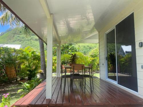 a porch with a table and chairs on it at FARE TITAINA in Hauru