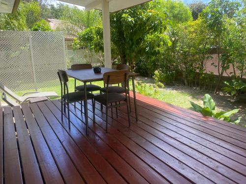 a wooden deck with a table and chairs on it at FARE TITAINA in Hauru