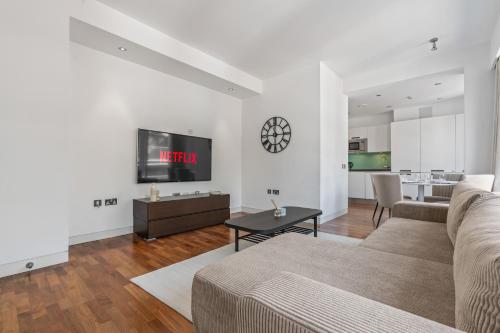 a living room with a couch and a table at Luxury Penthouse - Soho - Central - Sleeps 6 in London