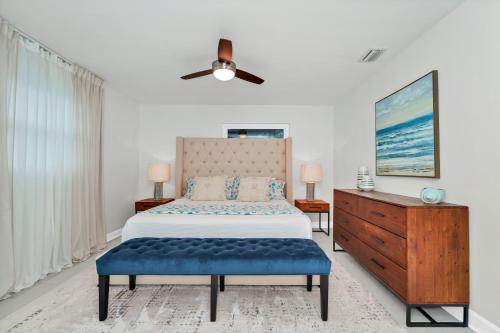 a bedroom with a bed and a ceiling fan at Lexy Beach House in Cape Canaveral