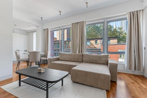 a living room with a couch and a table at Luxury Penthouse - Soho - Central - Sleeps 6 in London