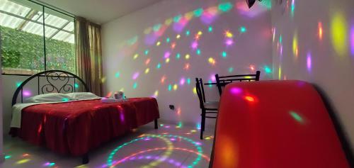 a bedroom with a bed with lights on the wall at Hospedaje El Paraiso in Santa Eulalia