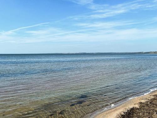 a large body of water with a sandy beach at 6 person holiday home in Farsø-By Traum in Farsø
