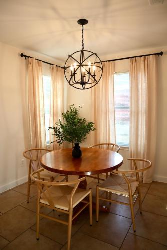 a dining room with a table and chairs and a chandelier at Lovely 3BR with King Bed,15 Min from Downtown Austin in Austin