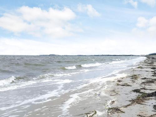 a view of the beach with the ocean at 7 person holiday home in Løgstør-By Traum in Løgsted
