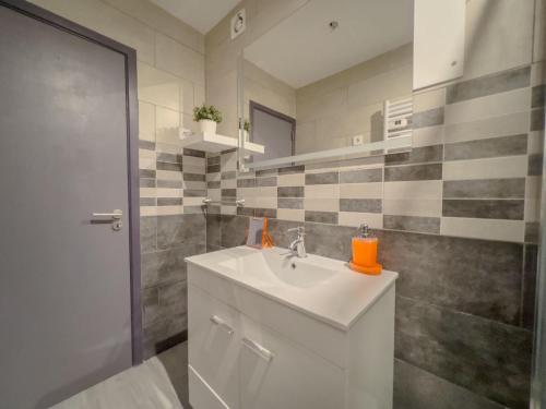 a bathroom with a white sink and a shower at StaySanto in Loures in Loures